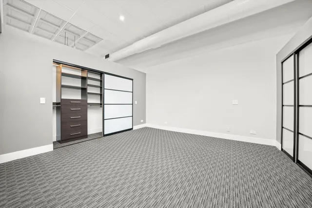 an empty room with a empty space and windows