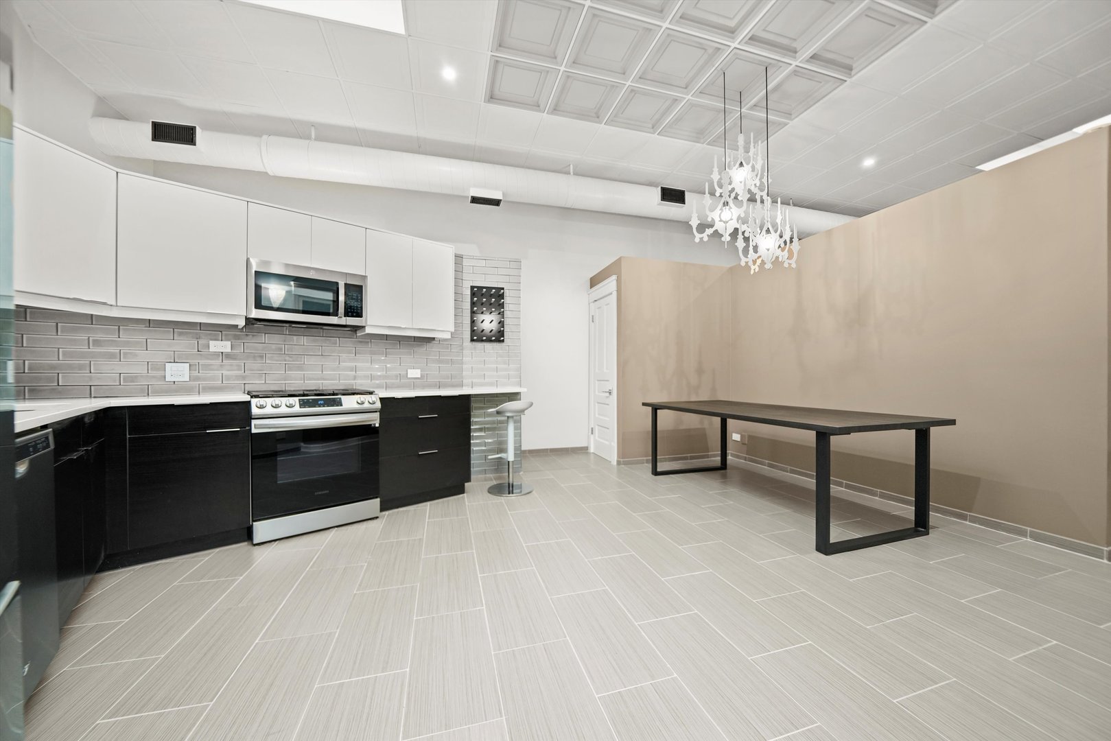 300 North Ogden Avenue, Unit 202 Chicago, IL 60607 - Photo 4 of 25 a kitchen with stainless steel appliances a stove sink microwave and cabinets