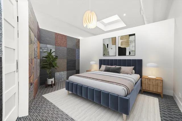 a bedroom with a large bed and a chandelier