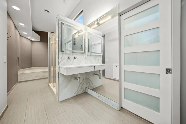 a bathroom with a double vanity sink and a mirror