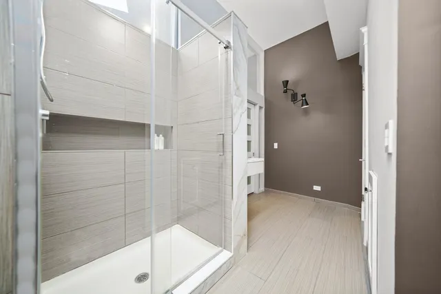 a bathroom with a shower and a glass door