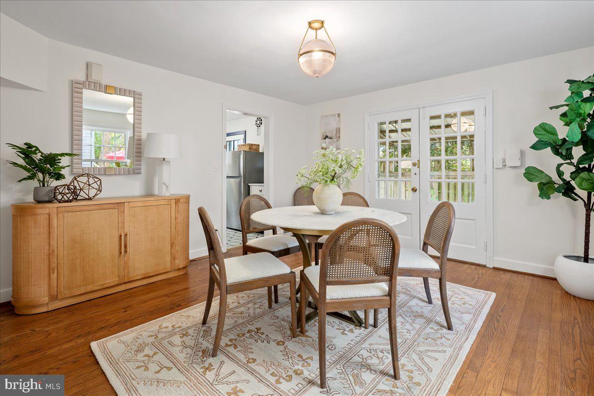 1606 North Springwood Drive Silver Spring, MD 20910 - Photo 12 of 36 a dining room with furniture potted plants and wooden floor