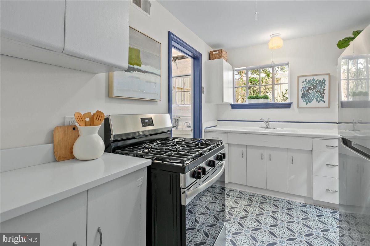1606 North Springwood Drive Silver Spring, MD 20910 - Photo 17 of 36 a kitchen with a stove a sink and a refrigerator