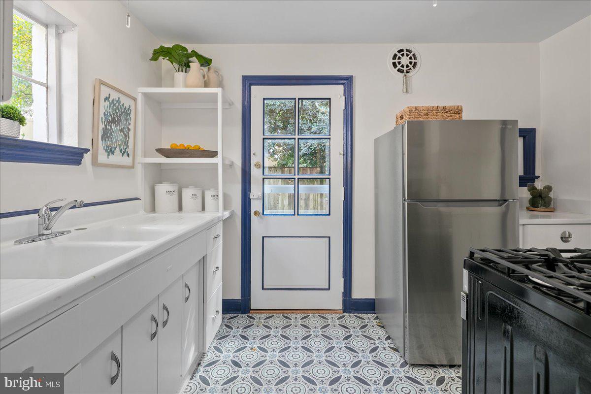 1606 North Springwood Drive Silver Spring, MD 20910 - Photo 18 of 36 a kitchen with a refrigerator sink and stove