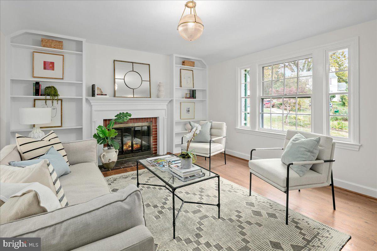 1606 North Springwood Drive Silver Spring, MD 20910 - Photo 7 of 36 a living room with furniture a flat screen tv and a fireplace