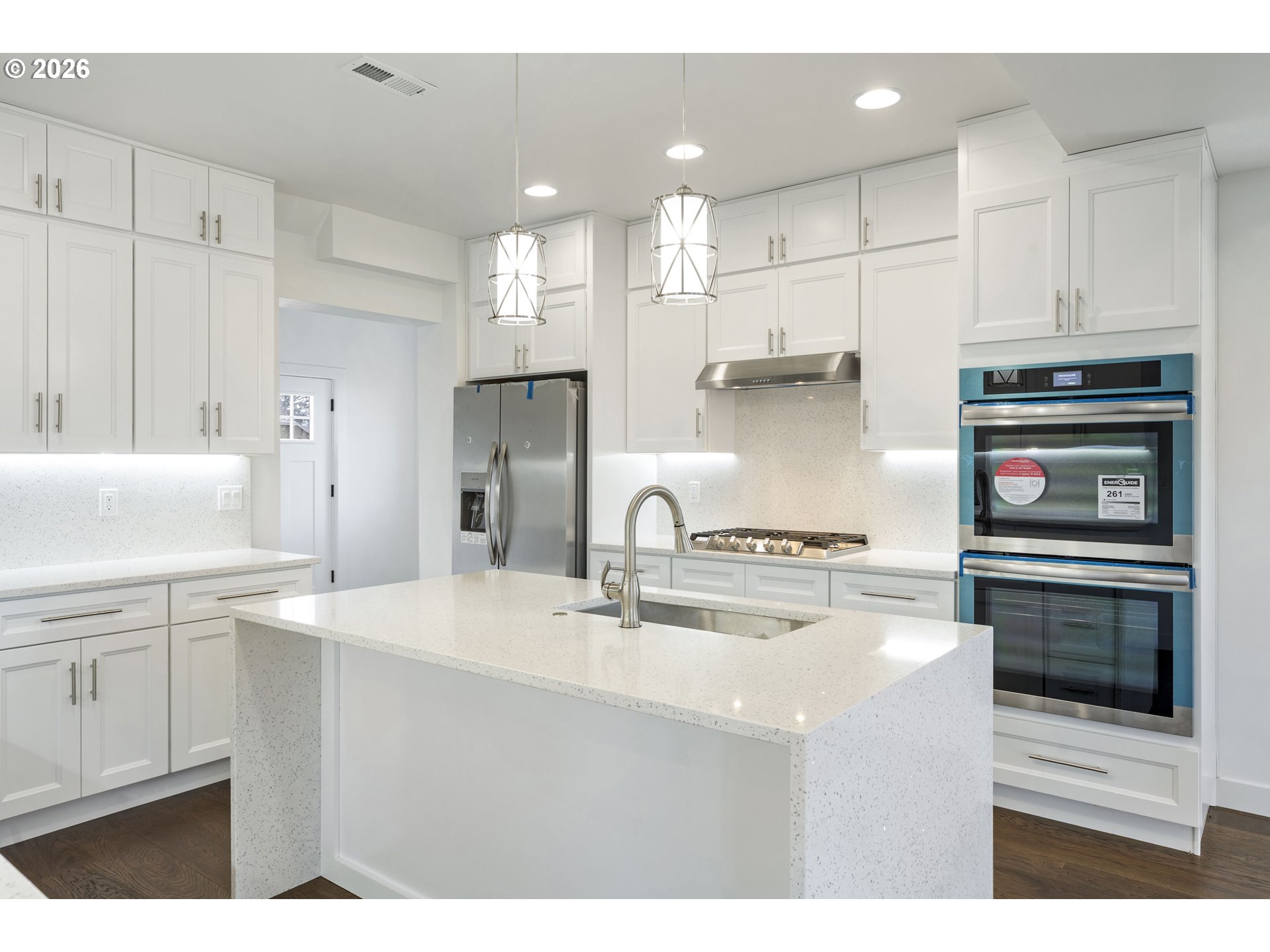 413 South Trade Street Amity, OR 97101 - Photo 8 of 42 a kitchen with kitchen island white cabinets and stainless steel appliances