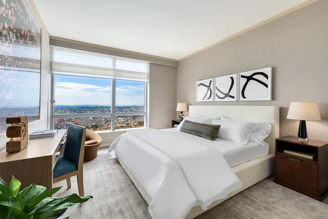 a bedroom with a bed and a large window