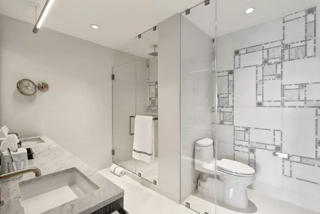 a bathroom with a sink toilet and shower