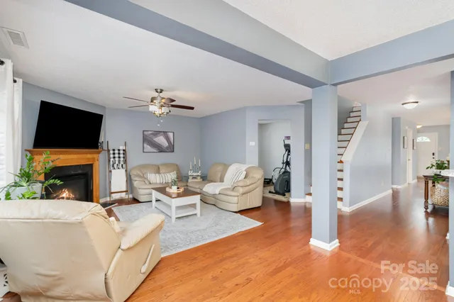 a living room with fireplace furniture and a flat screen tv