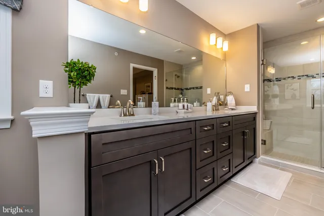a bathroom with a double vanity sink and a mirror