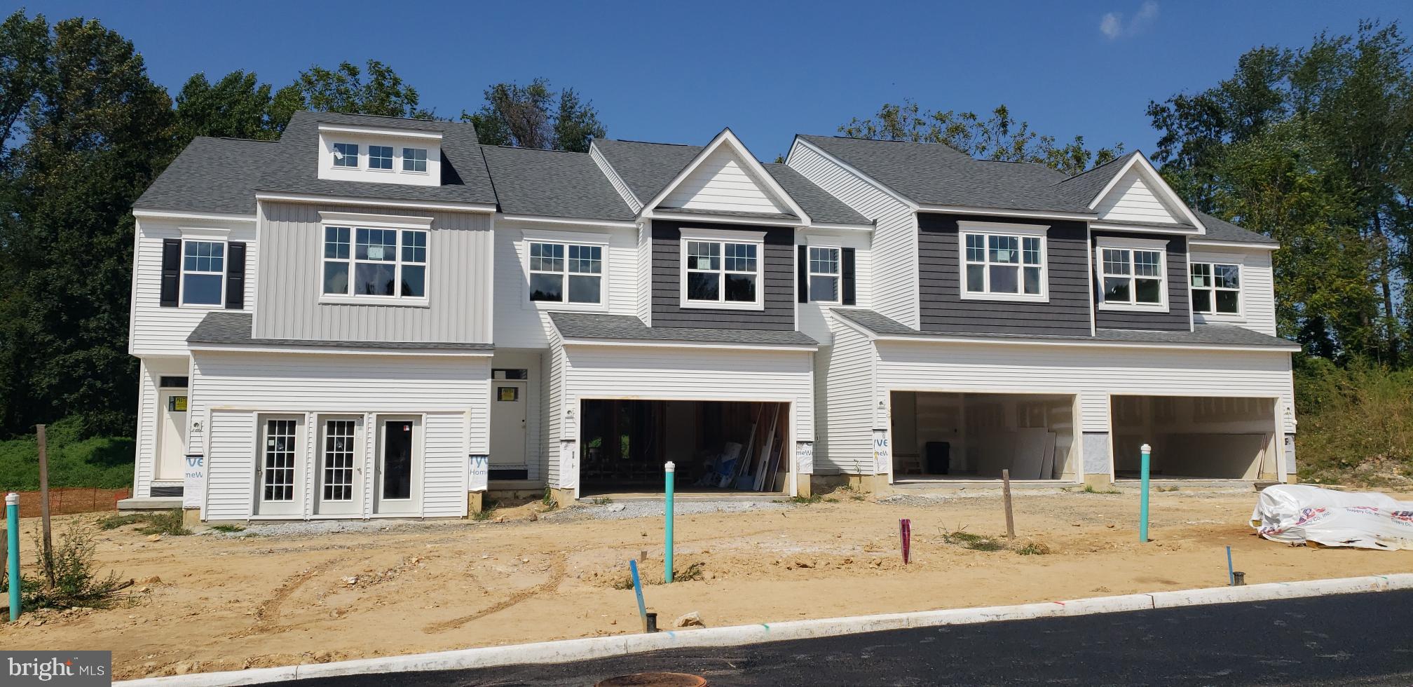 156 Bancroft Road, Unit SUTTON Kennett Square, PA 19348 - Photo 32 of 50 a view of a white house with large windows