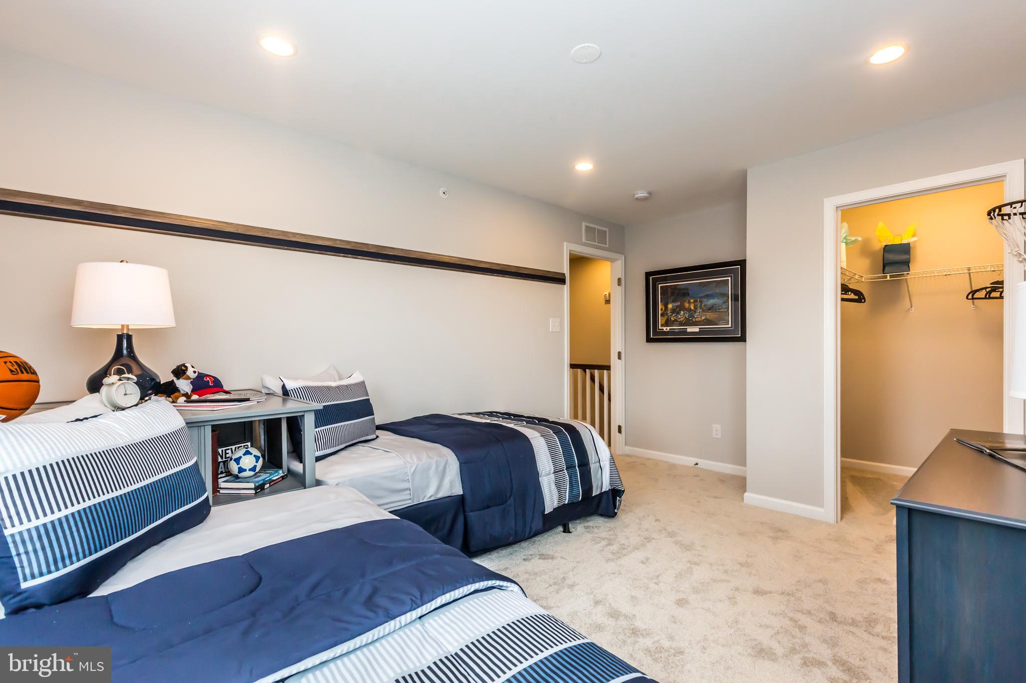 156 Bancroft Road, Unit SUTTON Kennett Square, PA 19348 - Photo 32 of 48 a bed room with a bed and a lamp