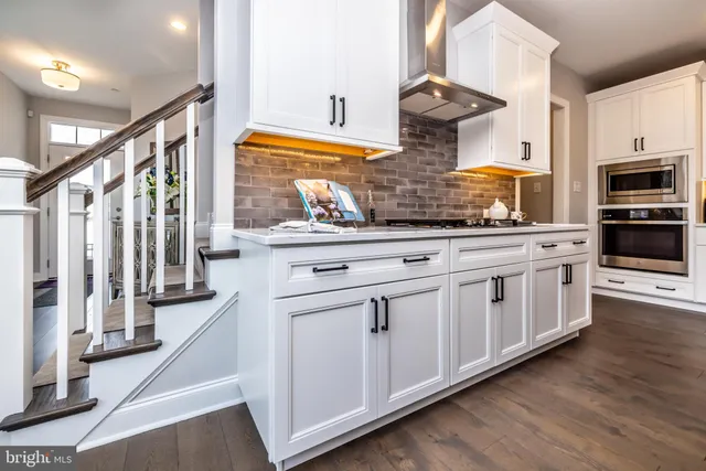 a kitchen with stainless steel appliances granite countertop a stove and a sink