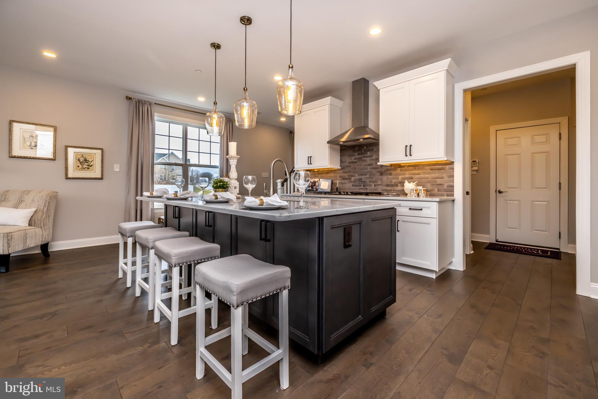 156 Bancroft Road, Unit SUTTON Kennett Square, PA 19348 - Photo 10 of 50 a kitchen with a dining table chairs and white cabinets