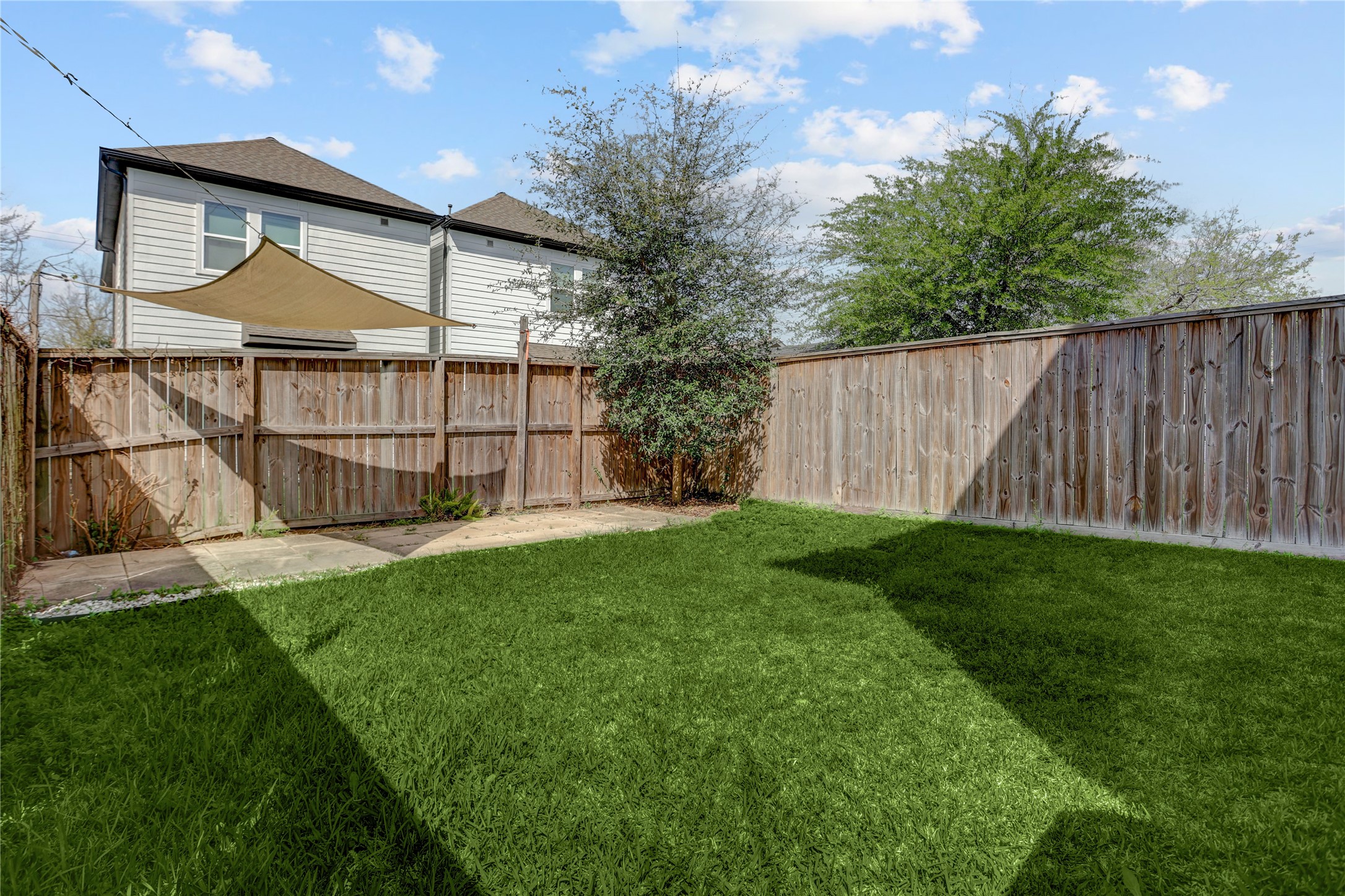 2413 Chapman Street Houston, TX 77009 - Photo 16 of 18 a view of backyard with small cabin and wooden fence