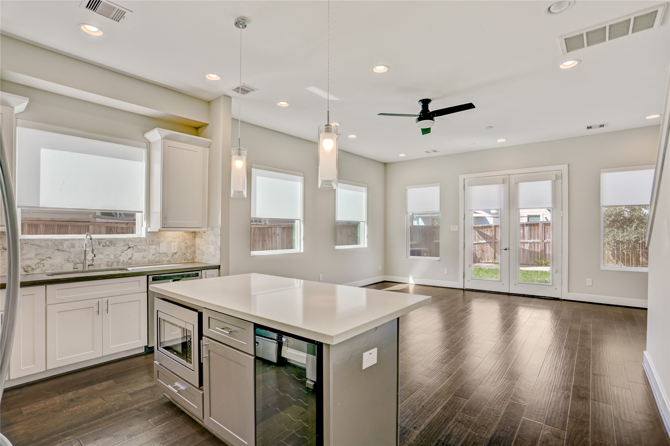 2413 Chapman Street Houston, TX 77009 - Photo 3 of 18 a open kitchen with stainless steel appliances granite countertop a sink and cabinets with wooden floor