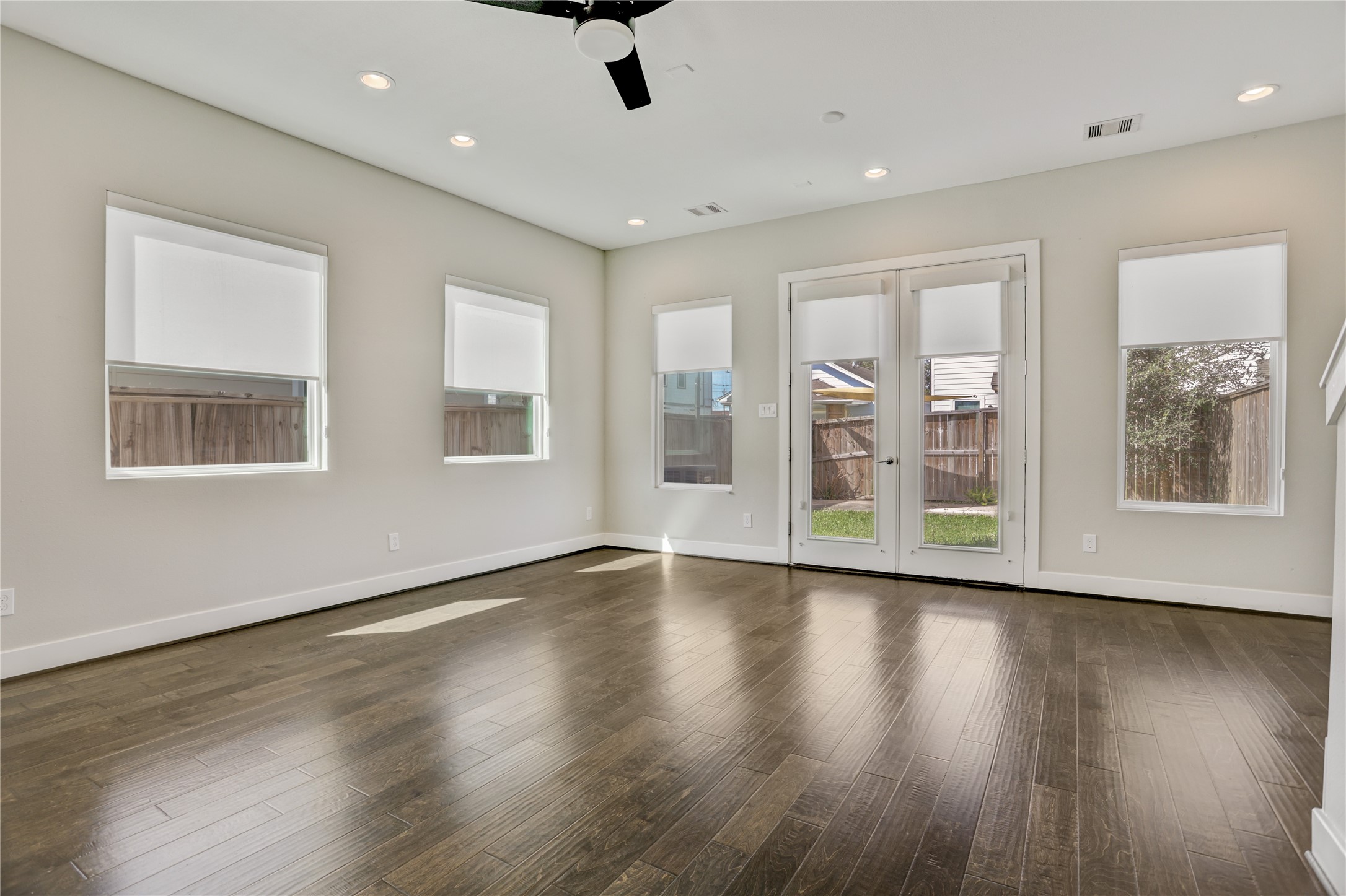 2413 Chapman Street Houston, TX 77009 - Photo 6 of 18 a view of an empty room with wooden floor and a window