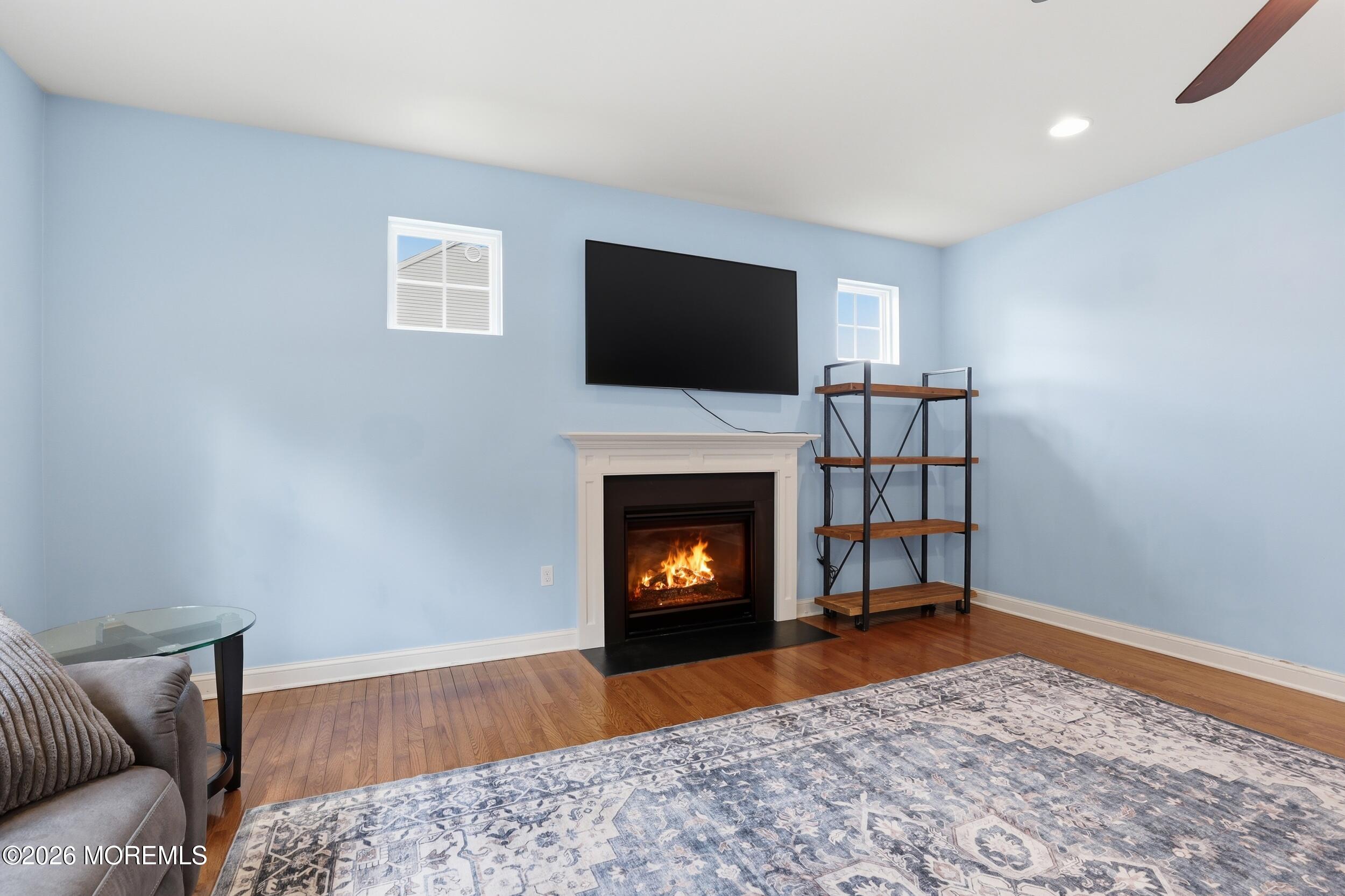 4 Firenze Road Jackson, NJ 08527 - Photo 17 of 57 a living room with furniture a flat screen tv and a fireplace