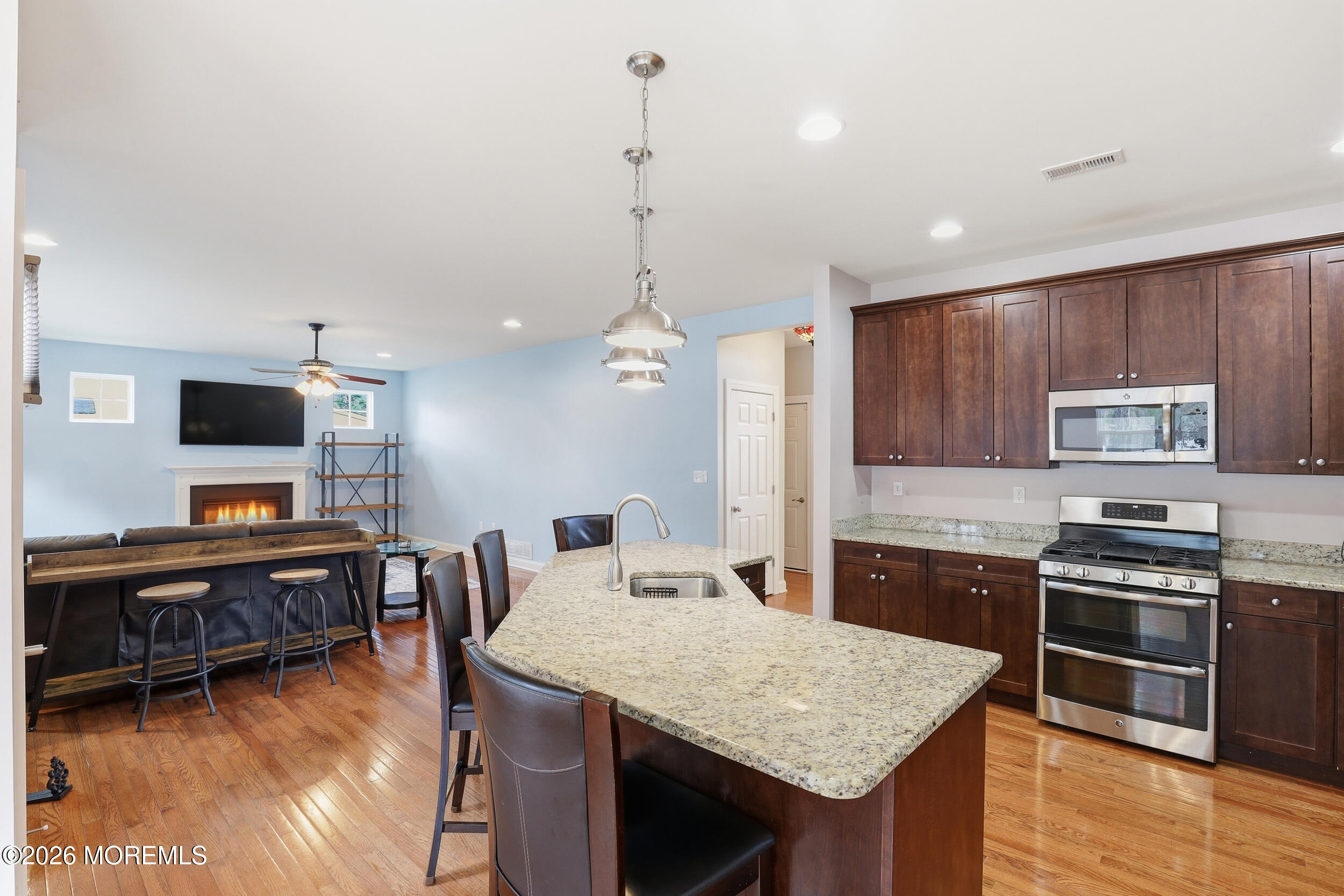 4 Firenze Road Jackson, NJ 08527 - Photo 18 of 57 a kitchen with stainless steel appliances granite countertop a sink stove and wooden floor