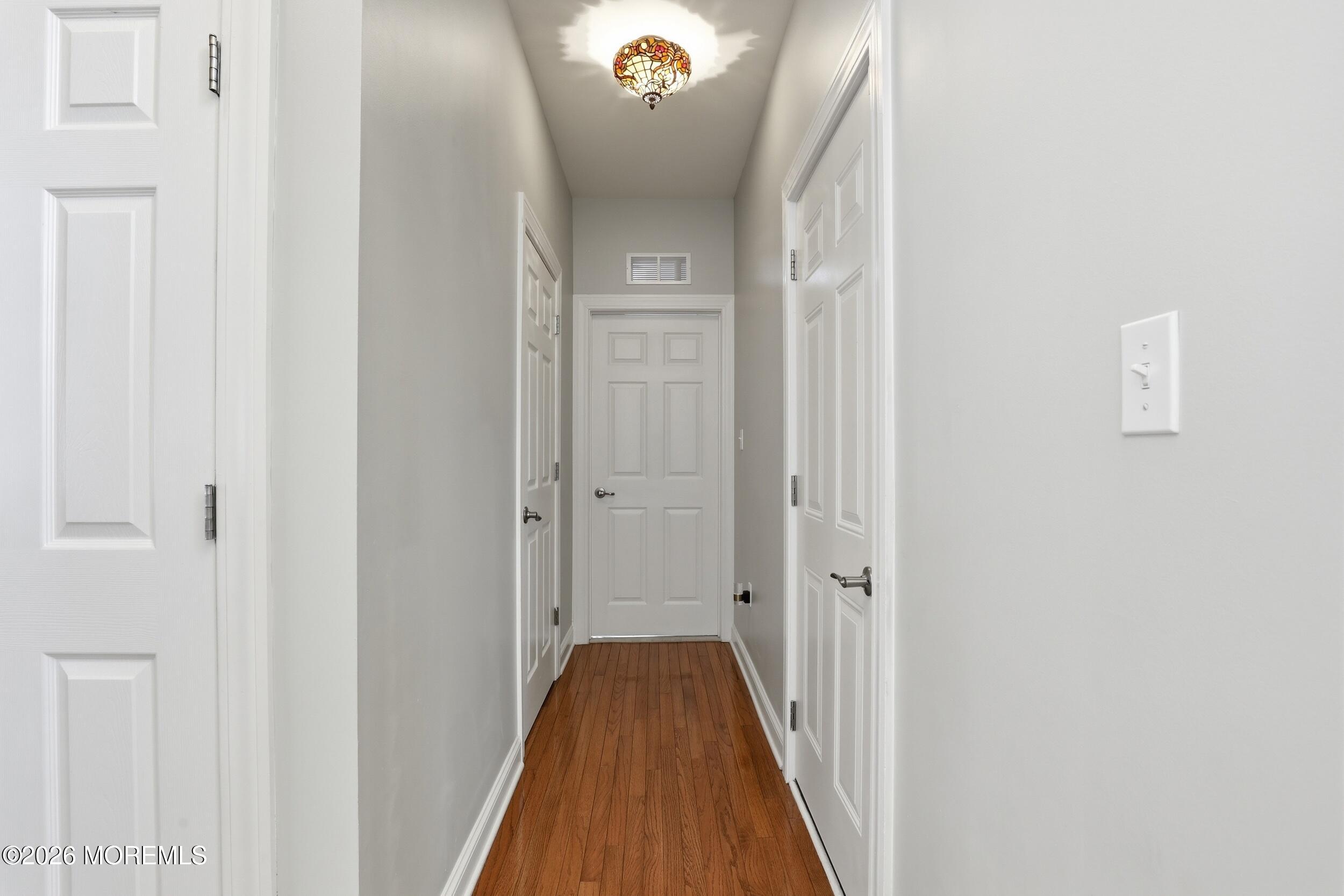 4 Firenze Road Jackson, NJ 08527 - Photo 22 of 57 a view of a hallway with wooden floor and staircase