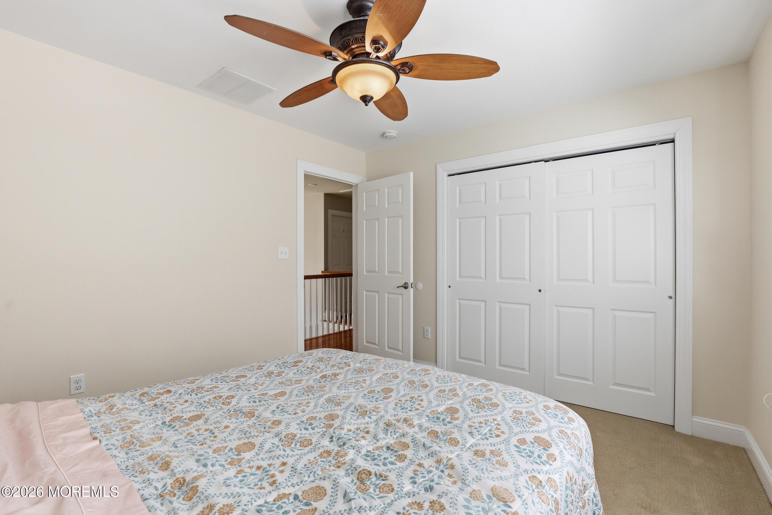 4 Firenze Road Jackson, NJ 08527 - Photo 32 of 57 a bedroom with a bed and a chandelier