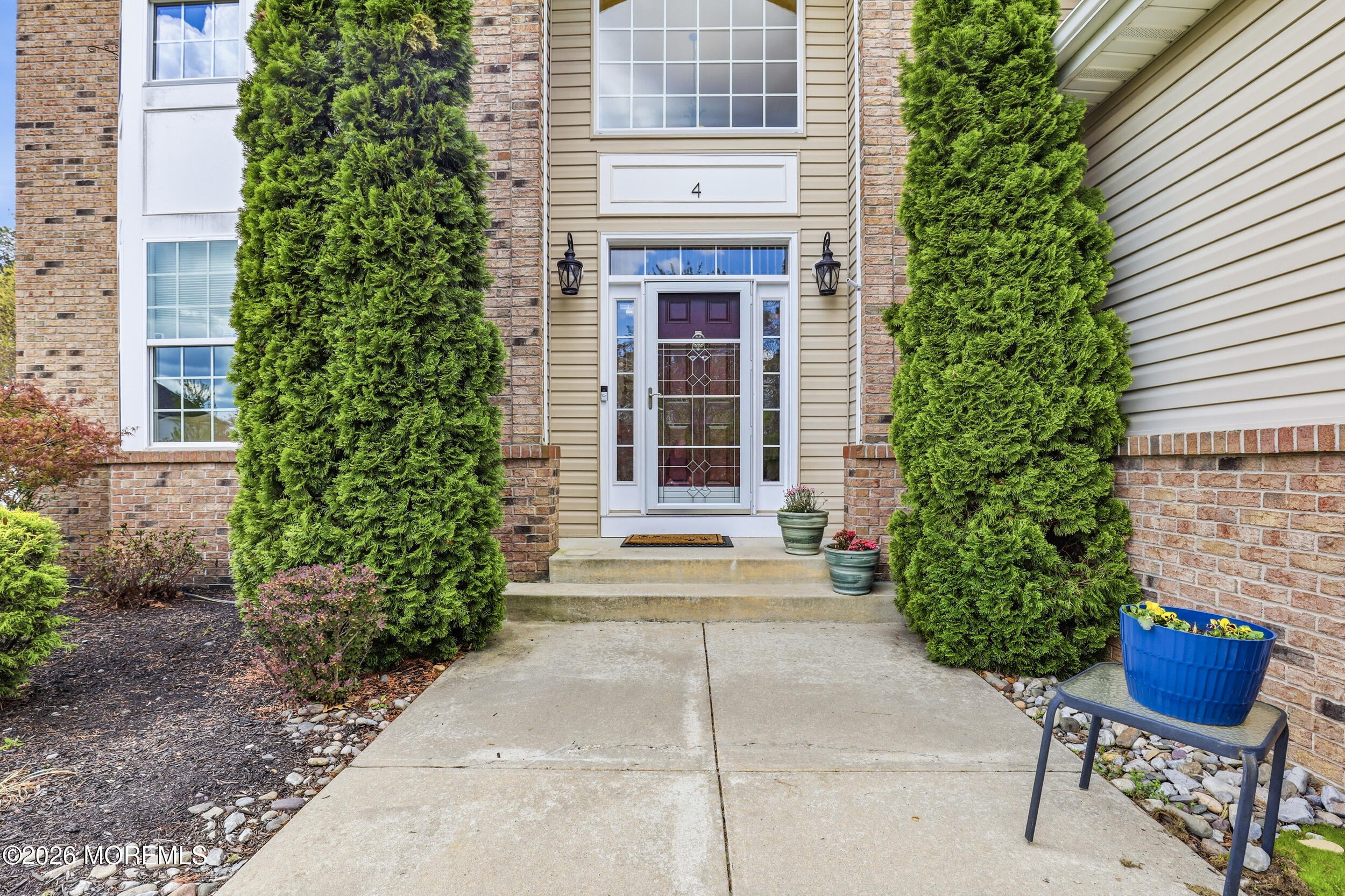 4 Firenze Road Jackson, NJ 08527 - Photo 4 of 57 a front view of a house with outdoor seating and plants