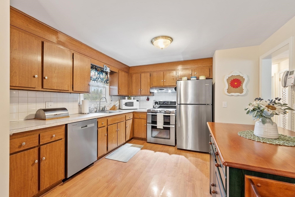 134 River Road Lowell, MA 01852 - Photo 13 of 36 a kitchen with granite countertop stainless steel appliances a refrigerator sink and microwave