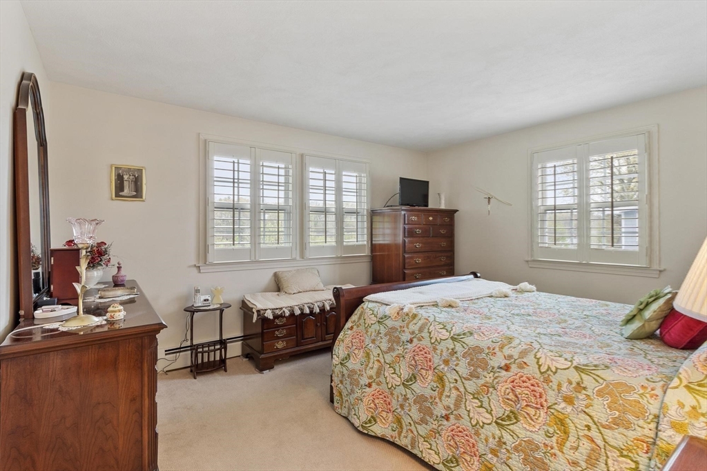 134 River Road Lowell, MA 01852 - Photo 16 of 36 a spacious bedroom with a bed and large windows