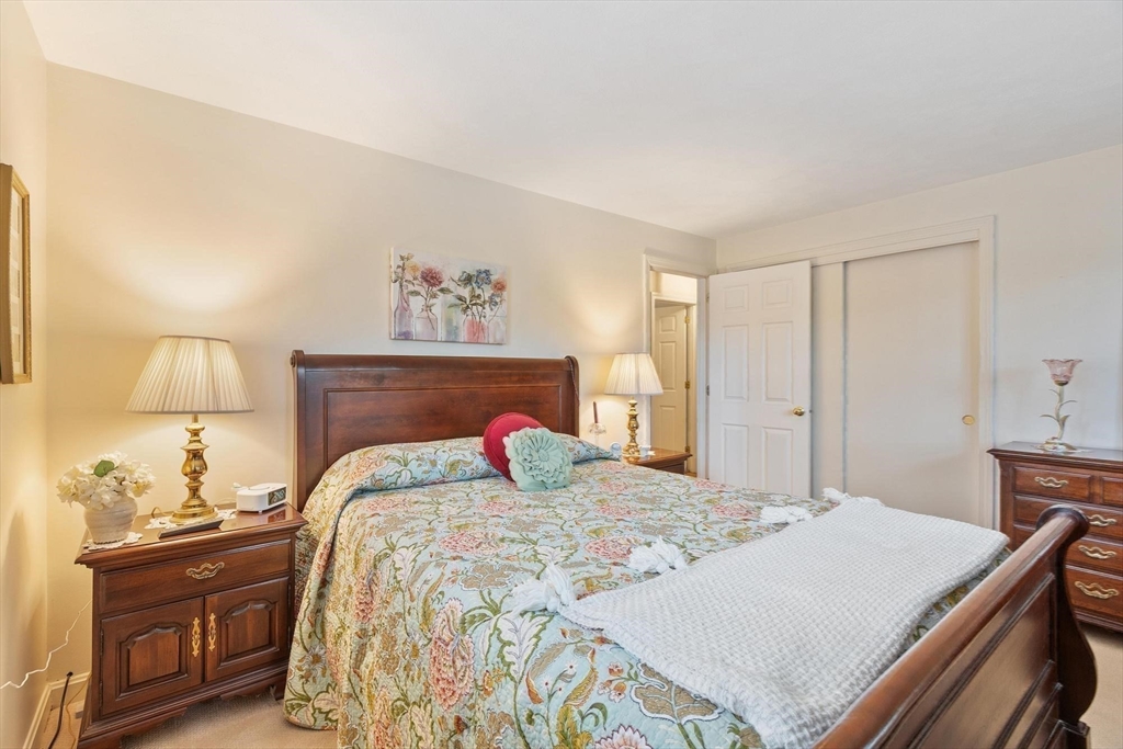 134 River Road Lowell, MA 01852 - Photo 17 of 36 a bedroom with a bed and a dresser in it