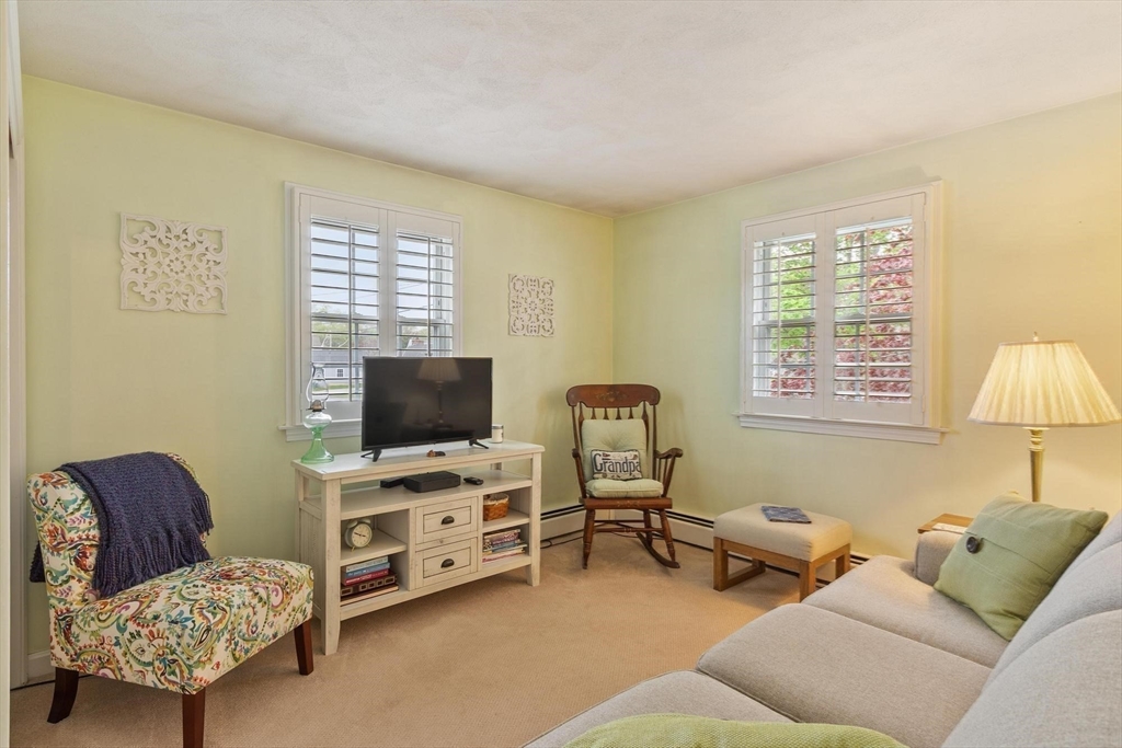 134 River Road Lowell, MA 01852 - Photo 20 of 36 a living room with furniture and a flat screen tv