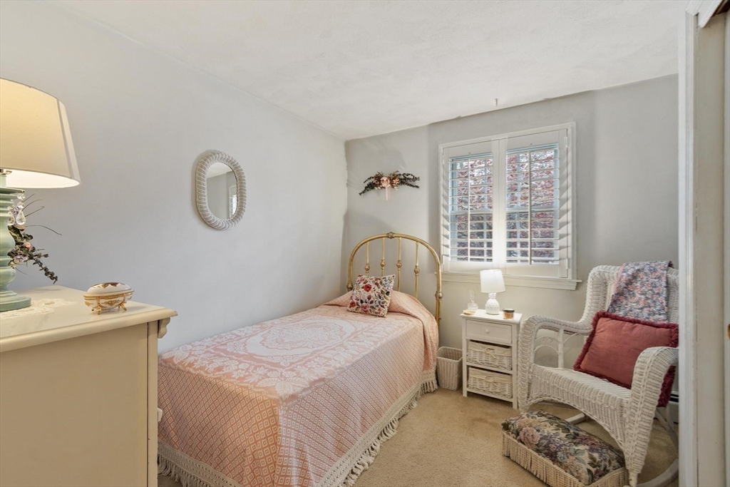 134 River Road Lowell, MA 01852 - Photo 23 of 36 a bedroom with a bed and a couch