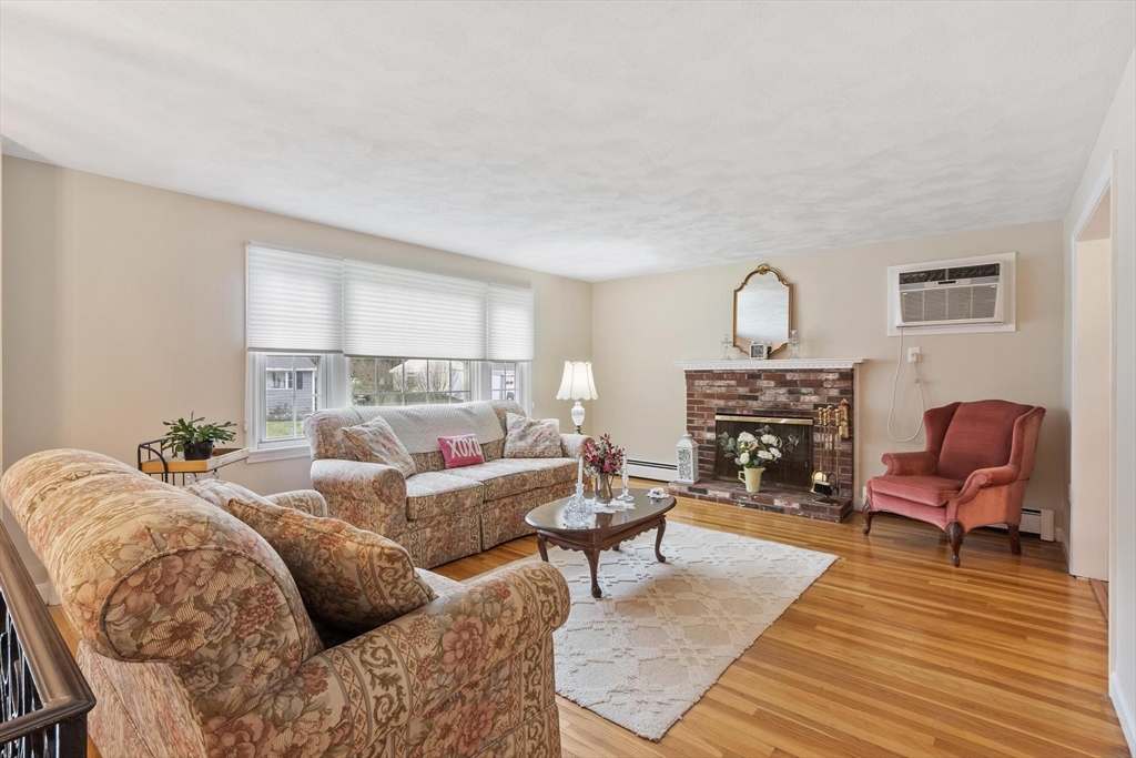 134 River Road Lowell, MA 01852 - Photo 3 of 36 a living room with furniture and a fireplace