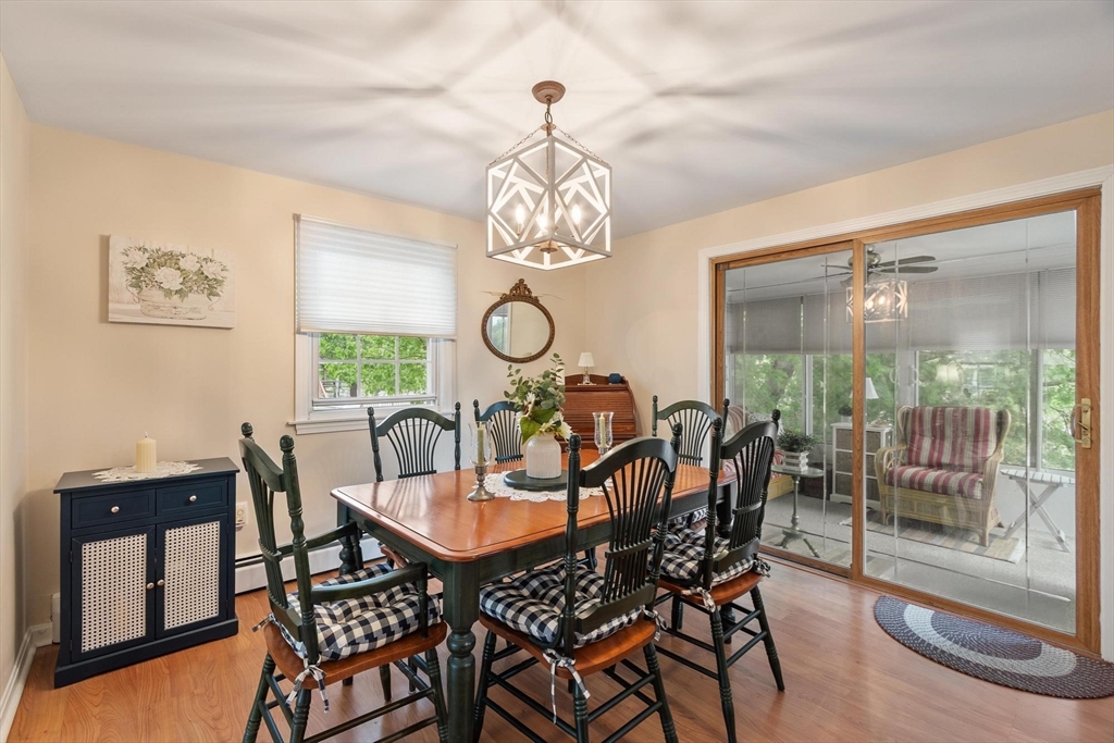 134 River Road Lowell, MA 01852 - Photo 8 of 36 a view of a dining room with furniture a chandelier and wooden floor