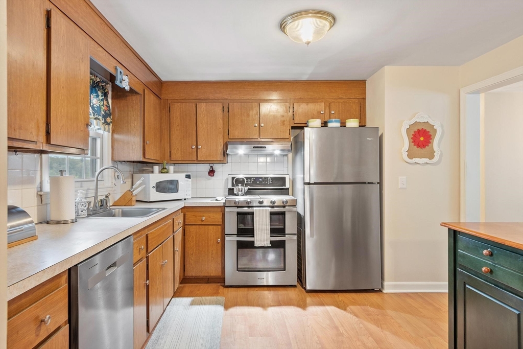 134 River Road Lowell, MA 01852 - Photo 10 of 36 a kitchen with stainless steel appliances granite countertop a refrigerator a stove and a sink