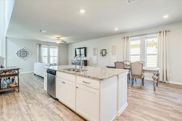 a view of living room with granite countertop furniture and wooden floor