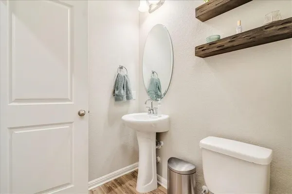 a bathroom with a sink a toilet and a mirror