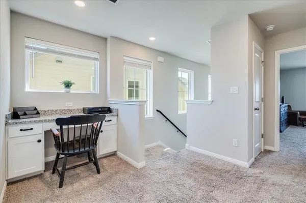 a workspace with furniture and window