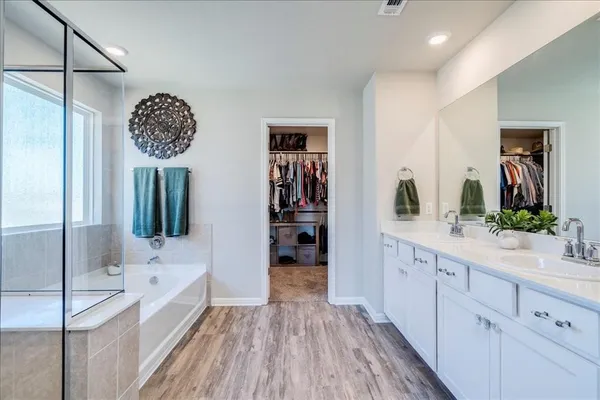 a bathroom with a double vanity sink and a mirror
