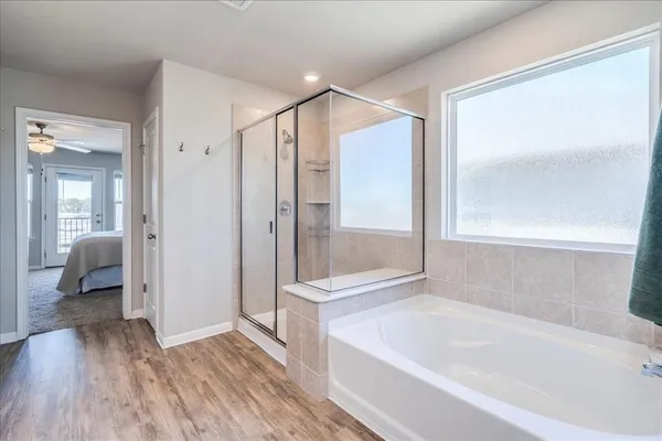 a bathroom with a bathtub and a shower