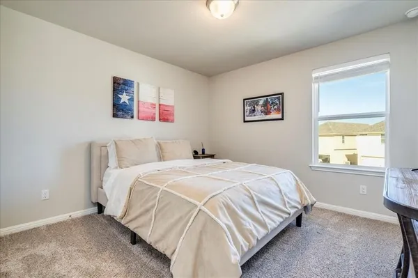 a bedroom with a bed and a window