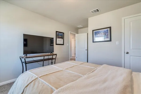 a bedroom with a bed and a flat screen tv