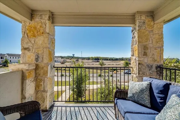 a view of a balcony with furniture