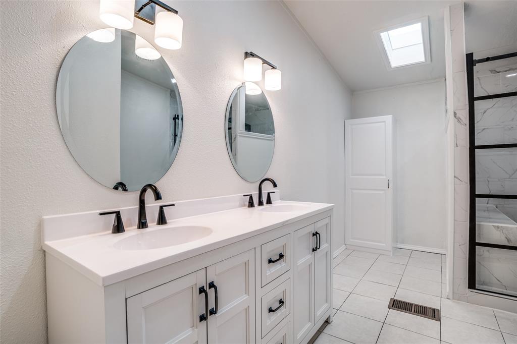9695 Olive Street Princeton, TX 75407 - Photo 13 of 23 Bathroom featuring a shower, double vanity, a sink, and visible vents
