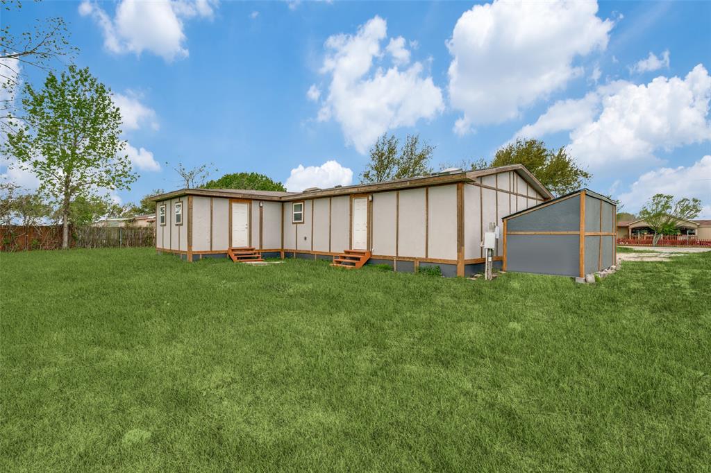 9695 Olive Street Princeton, TX 75407 - Photo 19 of 23 Back of house featuring entry steps, fence, and a yard