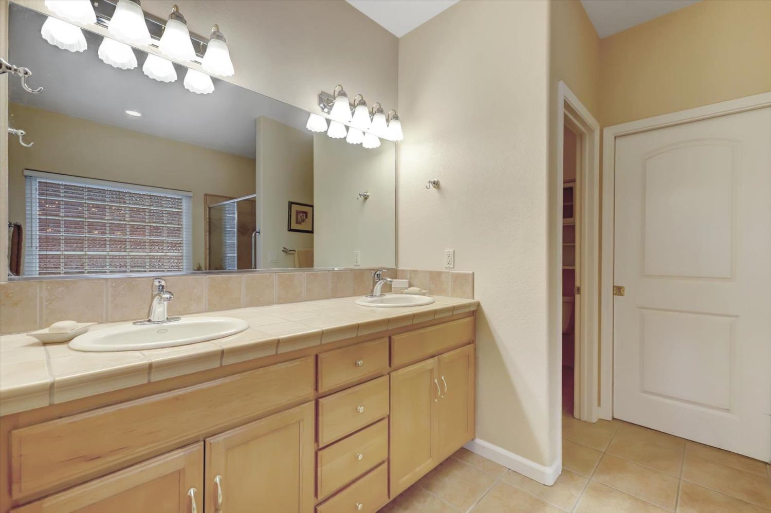 17036 Alice Way Grass Valley, CA 95949 - Photo 37 of 58 a bathroom with a double vanity sink and a mirror