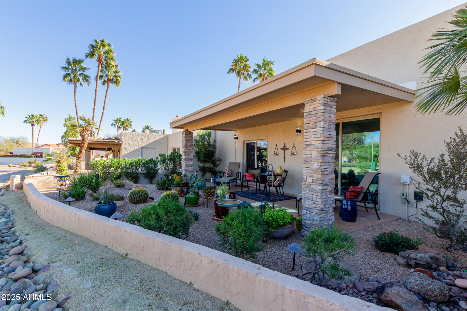 18718 East Rio Lane Rio Verde, AZ 85263 - Photo 13 of 59 a front view of a house with a yard and potted plants