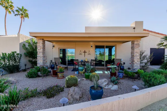 a view of a patio with plants and chairs