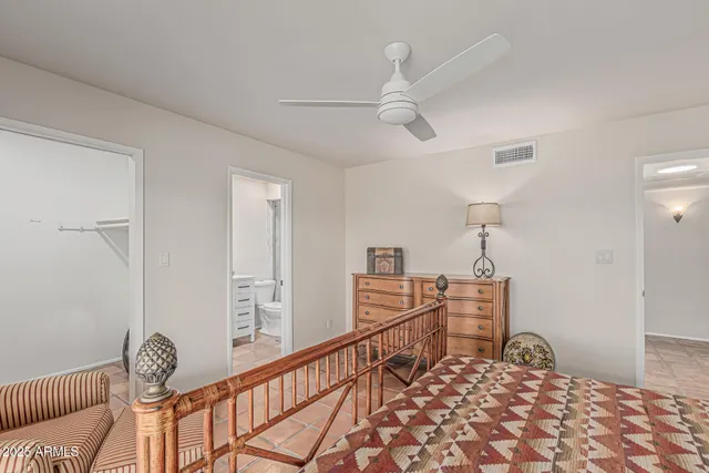 a bedroom with a large bed and a couch