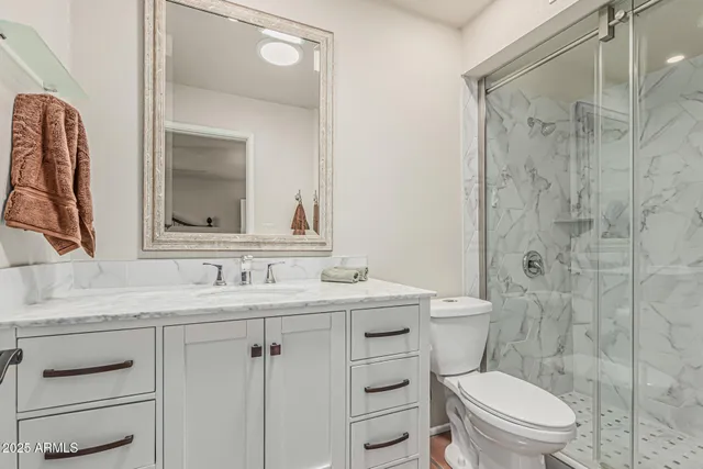 a bedroom with a bed and a painting on the wall