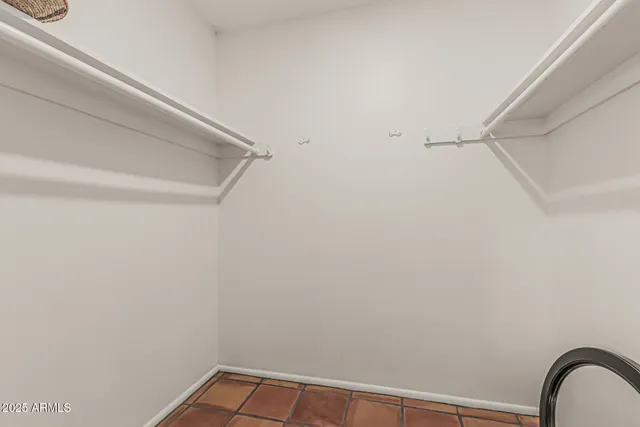 a bathroom with a granite countertop toilet sink and mirror